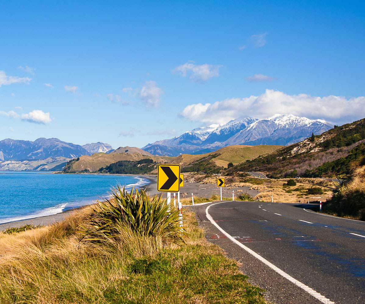 New Zealand vista with road, sea and mountain